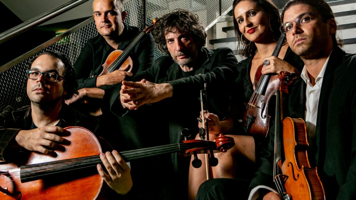 Neil Gaiman and FourPlay String Quartet will reunite for a premiere performance of their debut album, “Signs of Life,” at the Sydney Opera House | Listen to the captivating track, “In Transit”