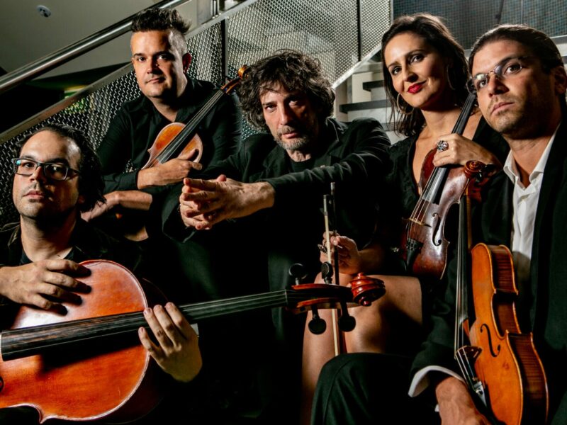 Neil Gaiman and FourPlay String Quartet will reunite for a premiere performance of their debut album, “Signs of Life,” at the Sydney Opera House | Listen to the captivating track, “In Transit”