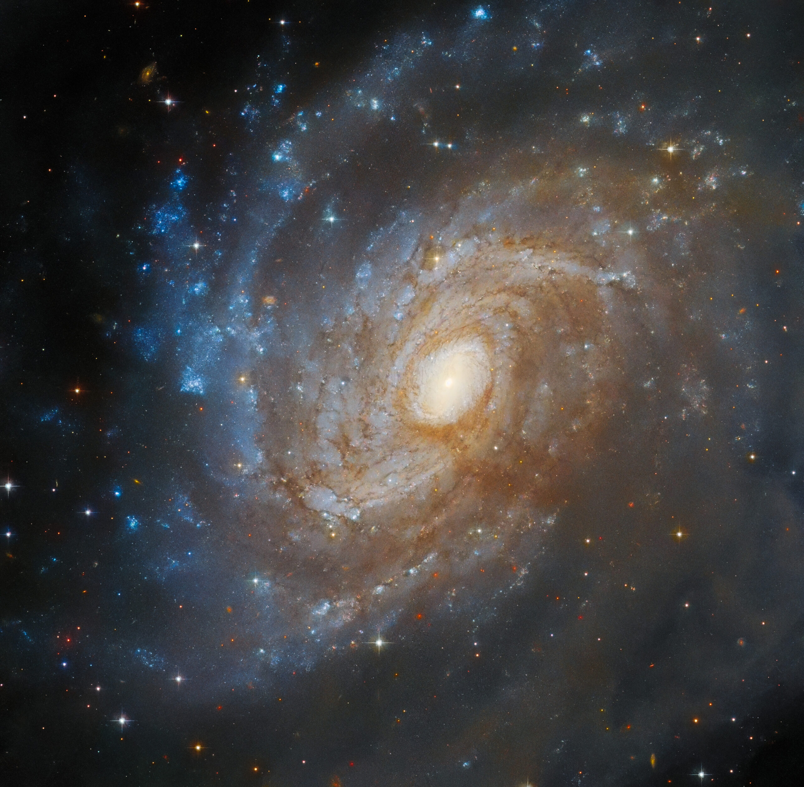 The Stunning Spiral: Hubble Captures the Intricate Beauty of Galaxy IC 4633, Hidden Within a Sea of Dust