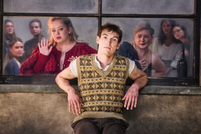 Still from National Theatre Live: The Playboy of the Western World, with Nicola Coughlan as Pegeen Mike at a Mayo pub bar in Caitriona McLaughlin's screen capture of J.M. Synge's comedy