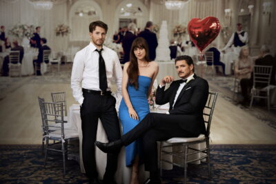 Backdrop still from Celine Song's Materialists, with Dakota Johnson as Manhattan matchmaker Lucy, opposite Pedro Pascal and Chris Evans.