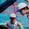 IDID 'FLY!' official music video still — K-pop group performing in a dynamic choreography scene