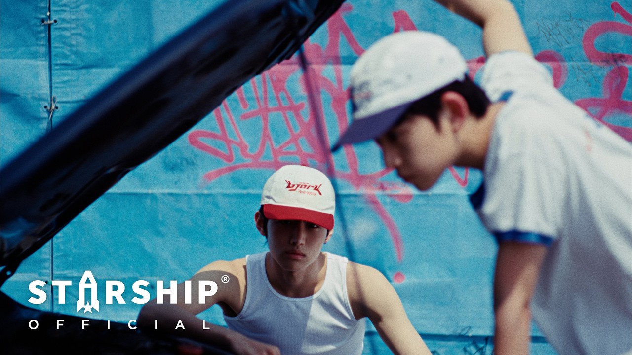 IDID 'FLY!' official music video still — K-pop group performing in a dynamic choreography scene