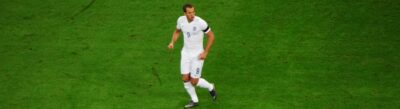 England captain Harry Kane in the white home shirt, running on the pitch