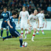 Lionel Messi, in the dark blue Argentina away shirt, striking the ball during an Argentina match.