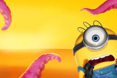 A wide-eyed Minion screams as pink monster tentacles rise against an orange sky in Pierre Coffin's animated film Minions & Monsters.