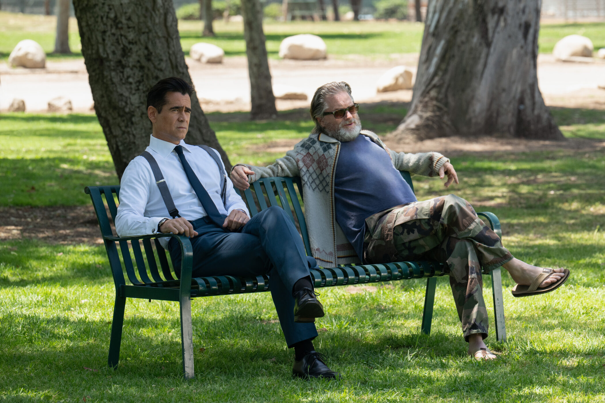 Colin Farrell in the Apple TV+ series Sugar, seated on a park bench.