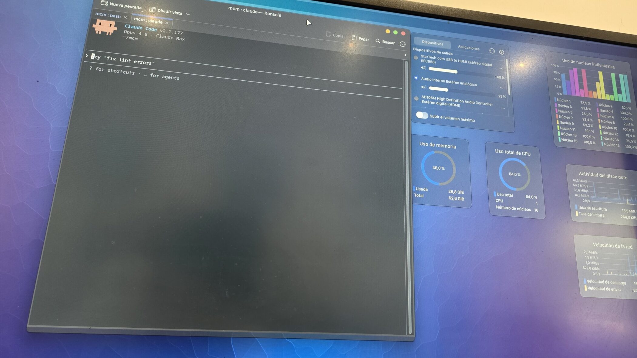A desktop monitor running a Claude Code terminal beside a Linux system monitor — the workstation behind the magazine.