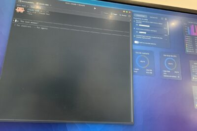 A desktop monitor running a Claude Code terminal beside a Linux system monitor — the workstation behind the magazine.