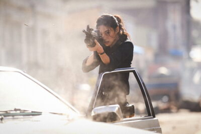 A still from Na Hong-jin's Hope, with officer Sung-ae firing a rifle in a smoke-filled street.