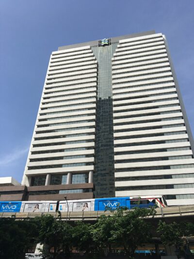 Standard Chartered bank branch exterior in Bangkok, Thailand, showing the bank's signage on a modern building facade.