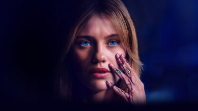 Lily Sullivan as the android Sara raises a bloodied hand to her face in Kate Dolan's Soulm8te.