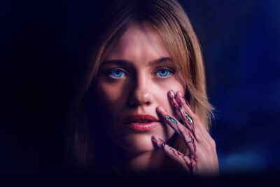 Lily Sullivan as the android Sara raises a bloodied hand to her face in Kate Dolan's Soulm8te.