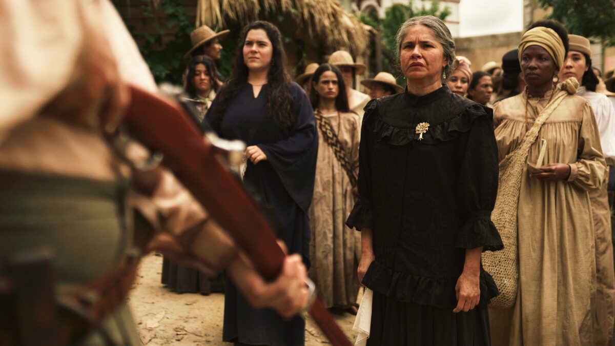 The women of Macondo face a soldier at gunpoint in One Hundred Years of Solitude Season 2