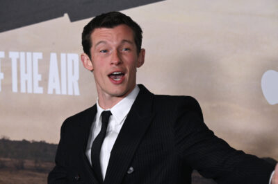 Callum Turner in a pinstripe suit on the red carpet at the Masters of the Air premiere in Los Angeles