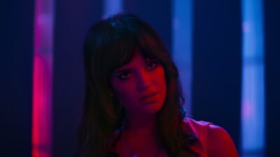 Sophie Thatcher as Elle in Nicolas Winding Refn's Her Private Hell, lit in red and blue neon.