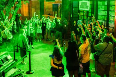Fans raising their fists at the Lanterns Training Headquarters activation at Comic-Con