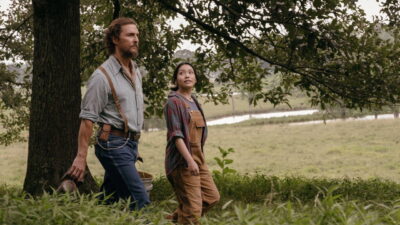 Matthew McConaughey as beekeeper Amziah King walks a rural field with Angelina LookingGlass as Kateri in Andrew Patterson's The Rivals of Amziah King.