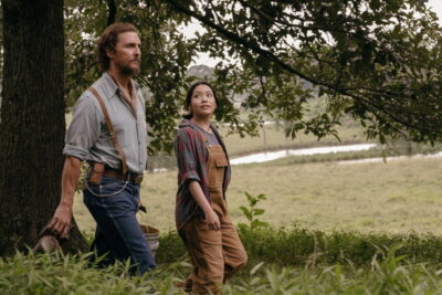 Matthew McConaughey as beekeeper Amziah King walks a rural field with Angelina LookingGlass as Kateri in Andrew Patterson's The Rivals of Amziah King.