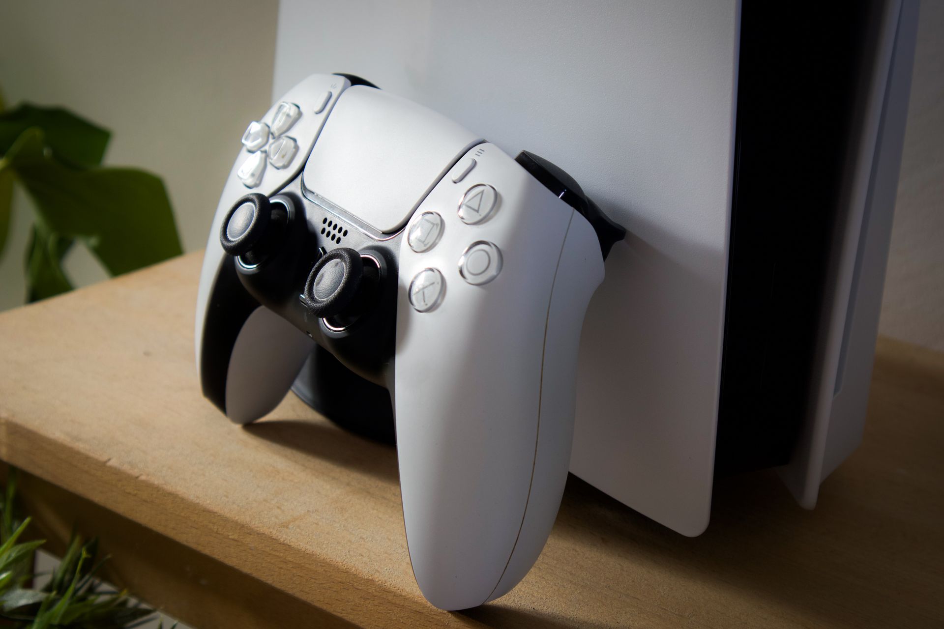 Close-up of a PlayStation 5 console with DualSense controller