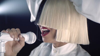 Sia performs in her signature platinum bob wig in the concert film Sia: Nostalgic for the Present, co-directed by Sia and Daniel Askill.