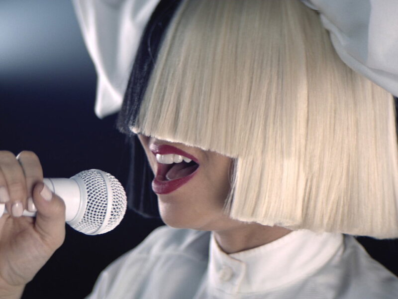 Sia hides her face and hands the stage to Maddie Ziegler in Nostalgic for the Present