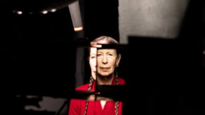 Composer and performer Meredith Monk seen through fragmented dark panels in Billy Shebar's documentary Monk in Pieces.