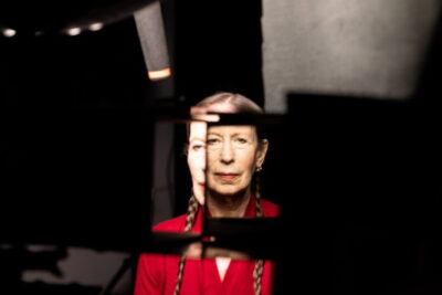 Composer and performer Meredith Monk seen through fragmented dark panels in Billy Shebar's documentary Monk in Pieces.