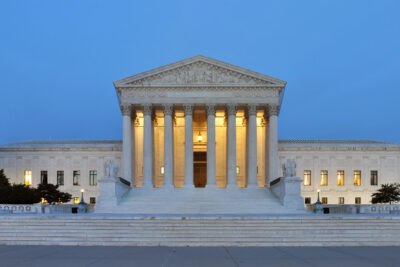 Facade of the United States Supreme Court Building at dusk