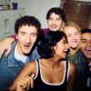 The five-friend ensemble of Adults crowded together in a small kitchen