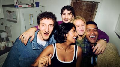The five-friend ensemble of Adults crowded together in a small kitchen
