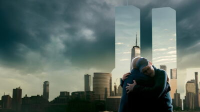 Two people embrace in the key art for the National Geographic documentary series 9/11 Reunited, with the Twin Towers outlined over the Manhattan skyline