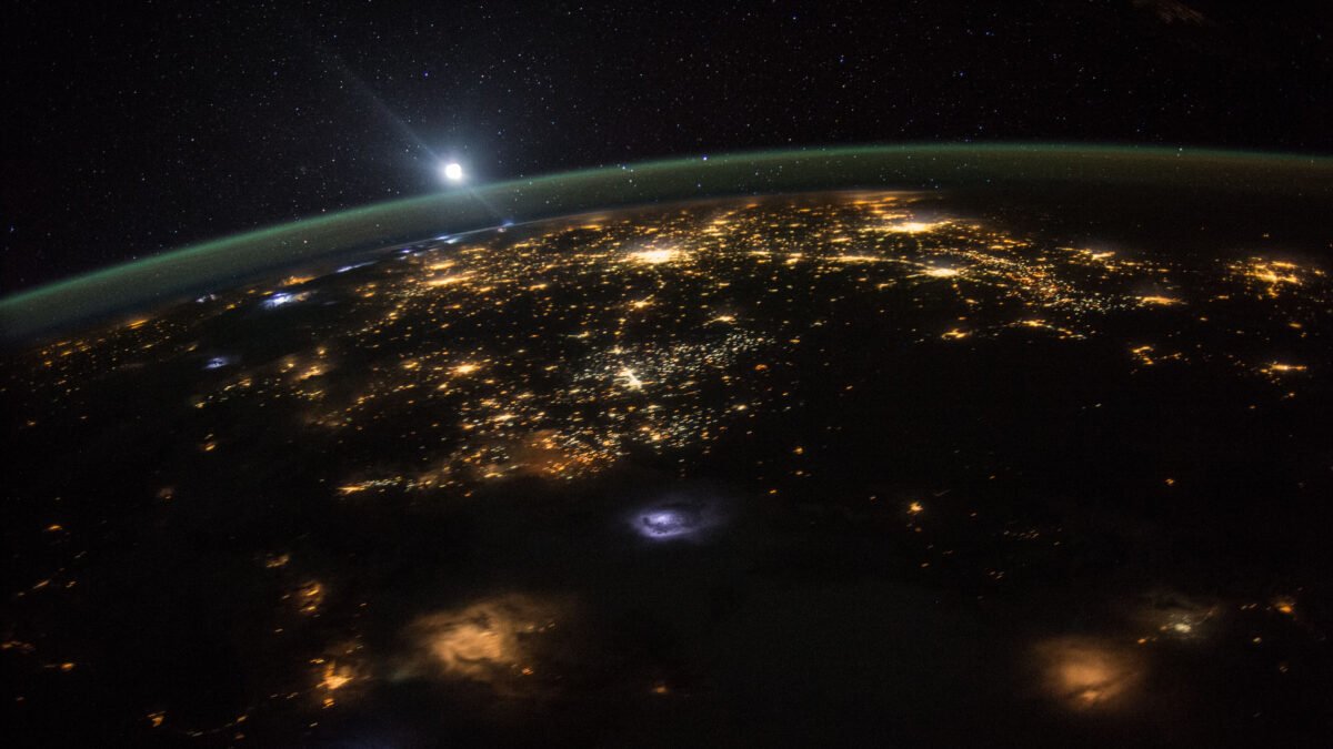 Earth city lights and aurora glow seen from the International Space Station at night