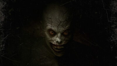 A cracked, hollow-eyed demon glares from the dark in Jeremiah Kipp's horror film The Mortuary Assistant.