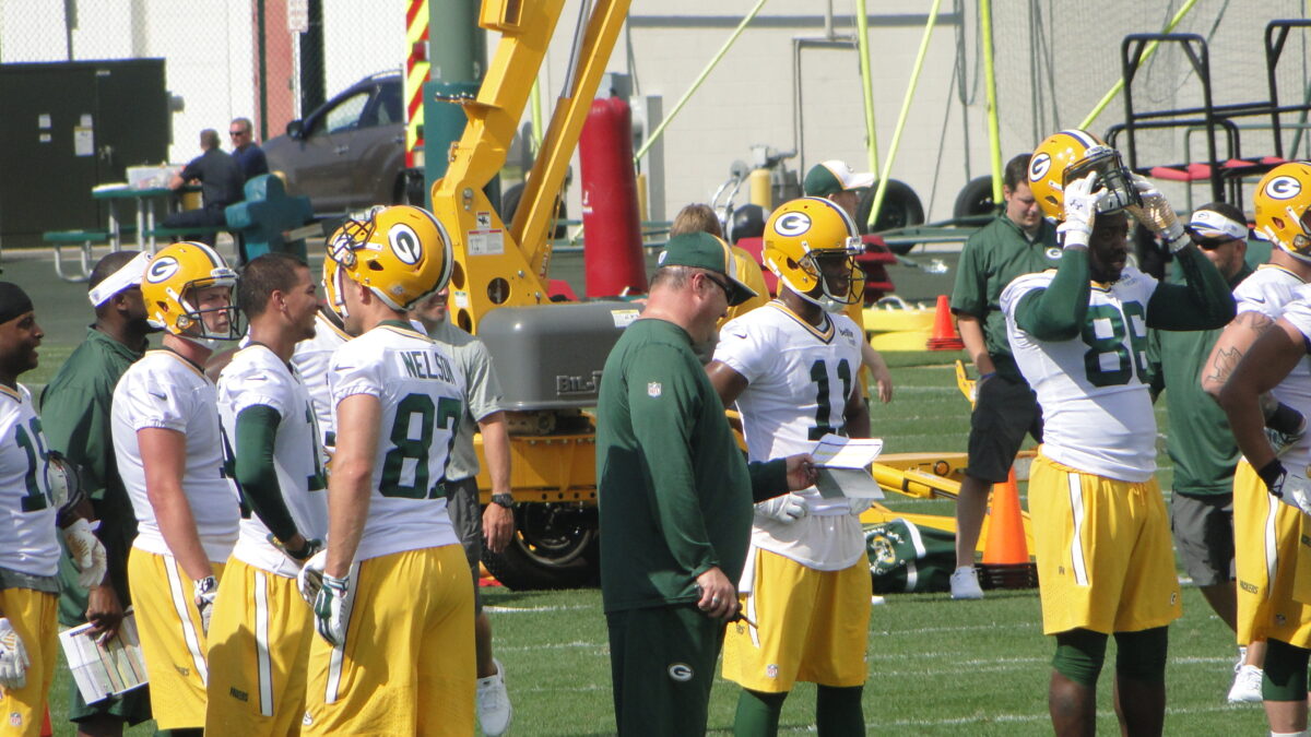 NFL players gathered on sideline during training camp