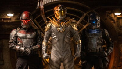 Three armored figures with the White Dragon at center in Aaron Schoenke's Legend of the White Dragon