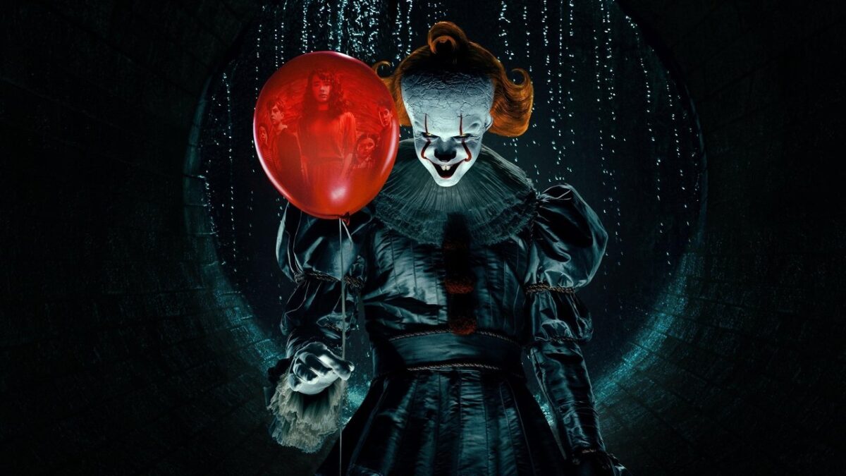 Pennywise the Dancing Clown holding a red balloon in IT: WELCOME TO DERRY