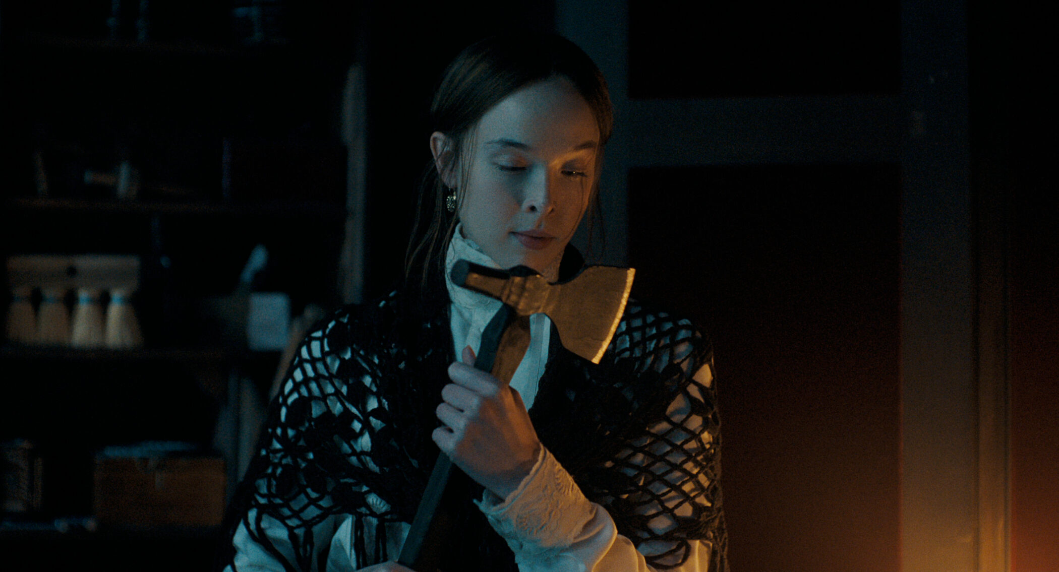 Ella Beatty as Lizzie Borden holding a hatchet in Monster: The Lizzie Borden Story