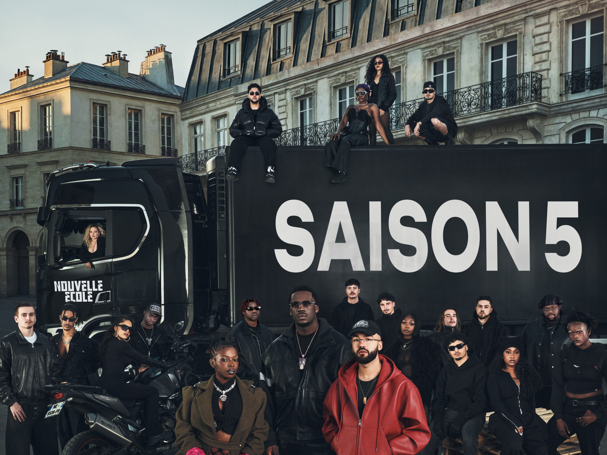 Cast and jury of Nouvelle École (Rhythm + Flow France) Season 5 in front of a black truck reading SAISON 5 on a Paris street