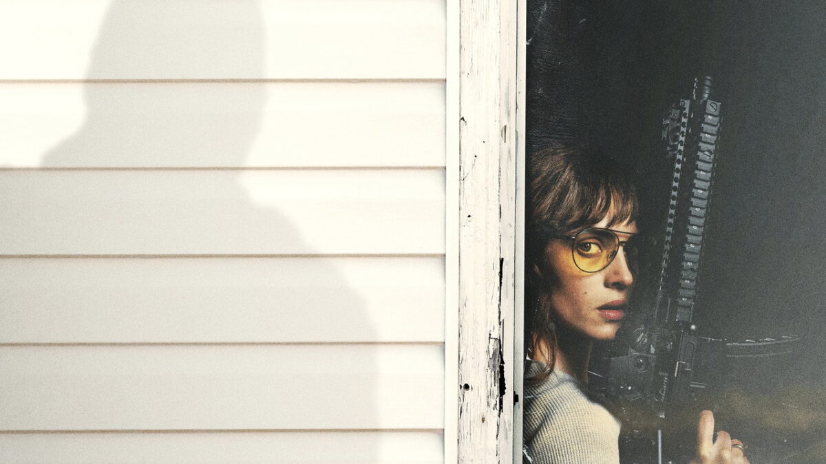 Adria Arjona takes cover with a rifle as a super-soldier looms in Onslaught directed by Adam Wingard 2026