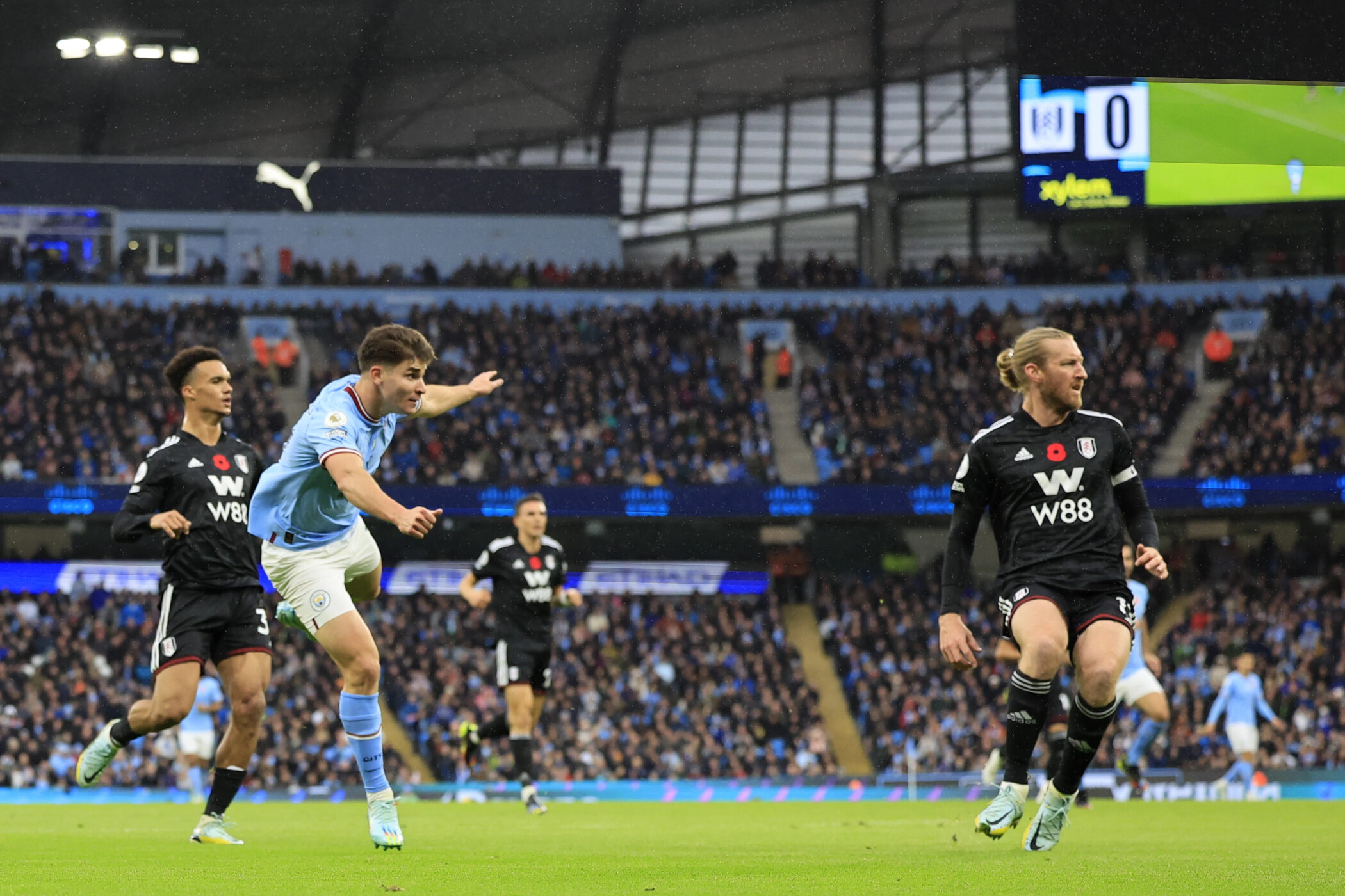 Premier League match action in a full stadium