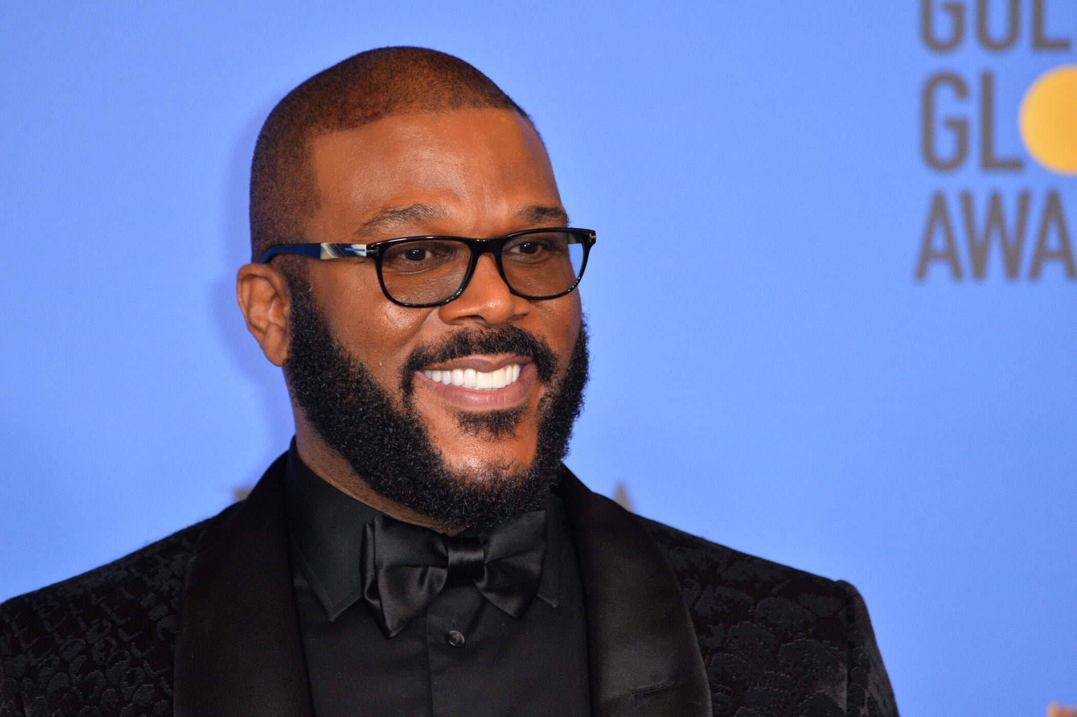 Tyler Perry in a black tuxedo on the Golden Globe Awards red carpet
