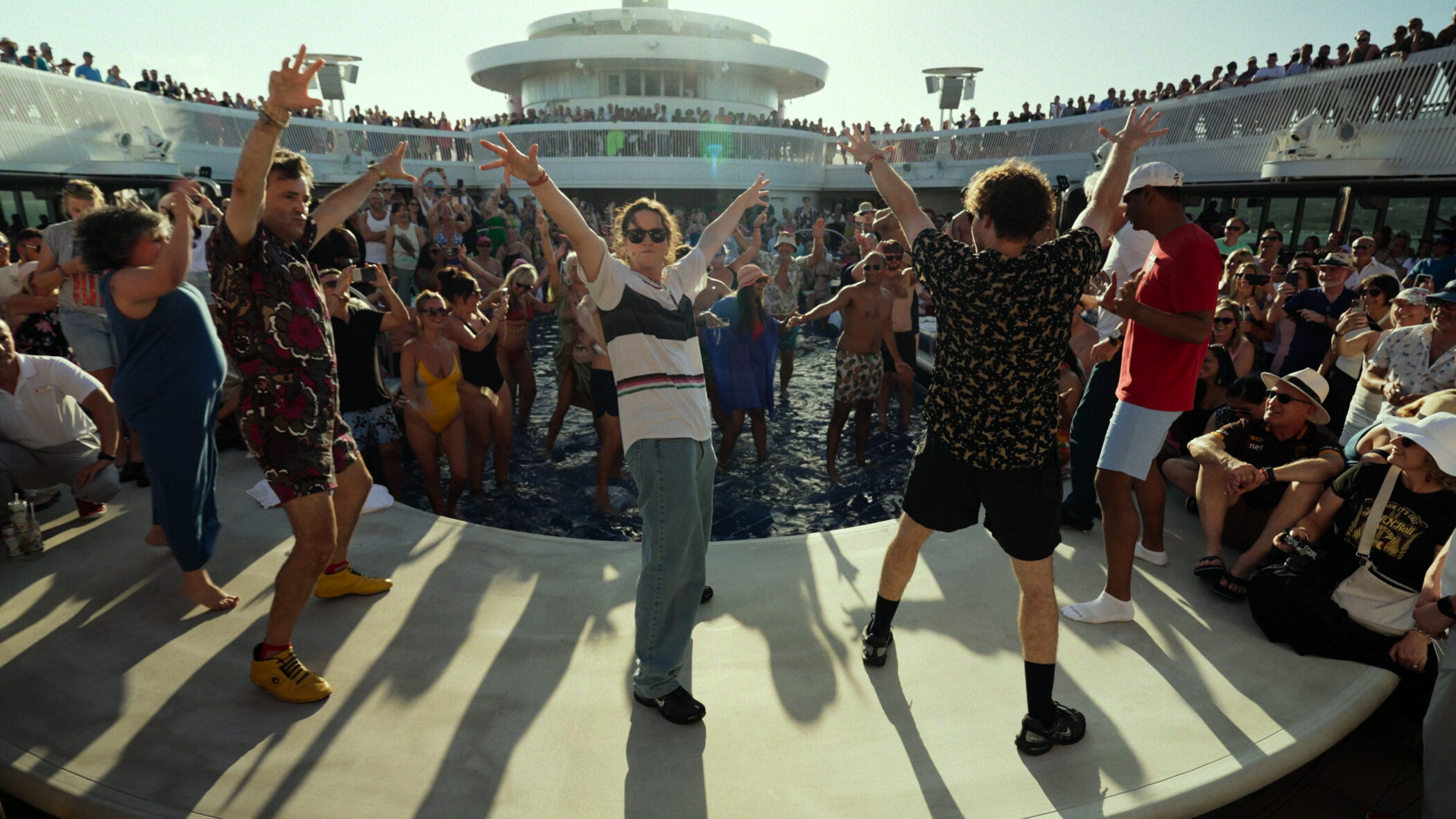 Dancers perform on a cruise ship deck in Untold Raygun: Breaking Badly