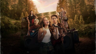The new Camp Rock campers gather around a giant speaker stack in Veronica Rodriguez's Camp Rock 3.