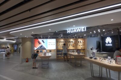 Huawei retail counter in Tonlin Plaza, Taoyuan, Taiwan, showing smartphones and the brand illuminated logo