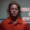 Key art for Unmasking a Monster: Aileen Wuornos showing the digitally recreated Aileen Wuornos seated in an orange prison jumpsuit