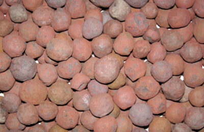 Close-up of reddish taconite iron ore pellets from the Great Lakes iron ranges