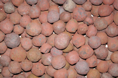 Close-up of reddish taconite iron ore pellets from the Great Lakes iron ranges