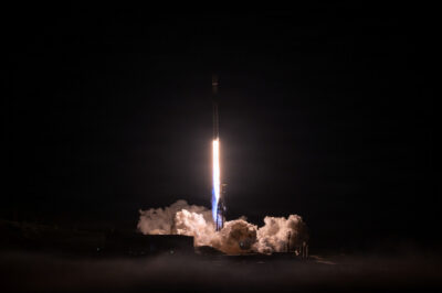 SpaceX Falcon 9 rocket lifting off at night from Vandenberg Space Force Base on a Transporter rideshare mission