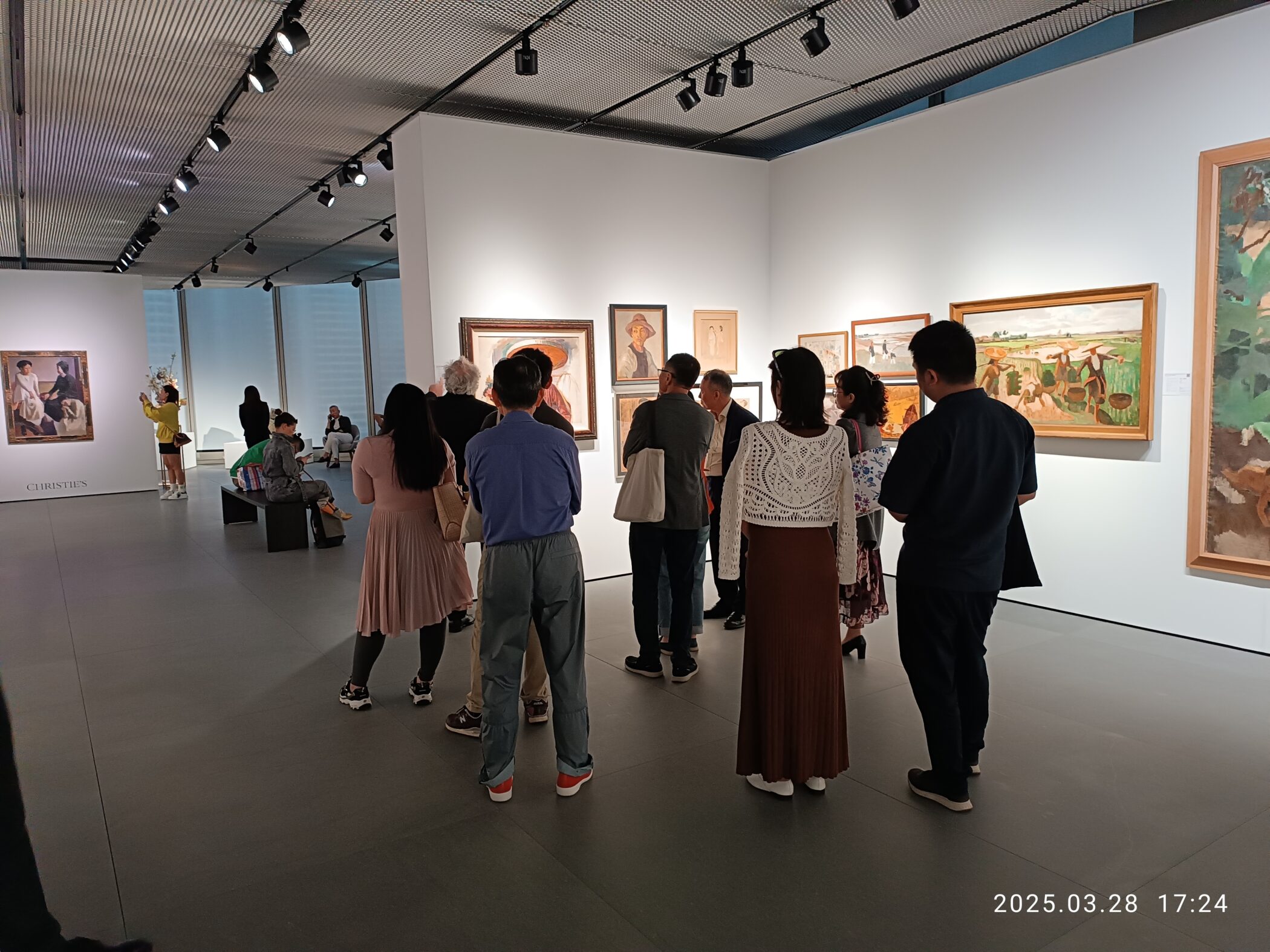 Visitors viewing paintings at Christies auction preview at The Henderson Hong Kong